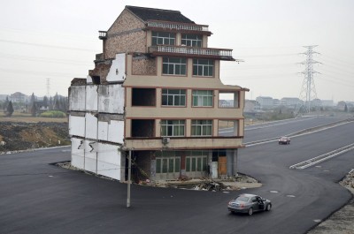 one-of-the-most-famous-nail-houses-in-china-this-home-in-wenling-zhejiang-province-belonged-to-an-elderly-couple-that-found-their-compensation-offer-inadequate-as-a-result-it-stands-in-the-middle-of-a-road-that-was-p.jpg