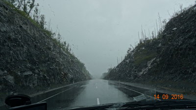 Сквозь тайфун и горы. А когда то здесь, за г. Вяземьск, по этим горам, кружили живописные серпантины, прям как в Крыму... И вот пришли иные времена, другие люди, и техника, и прогрызли гору, скучным разрезом.